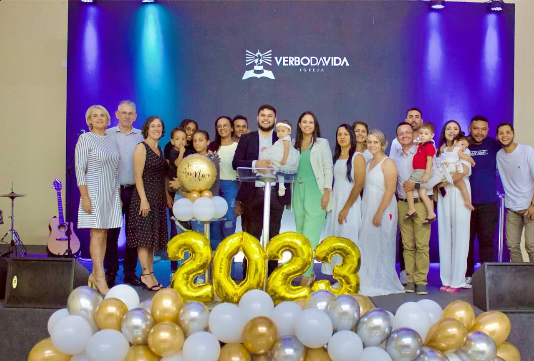 The church family on stage behind 2023 balloons