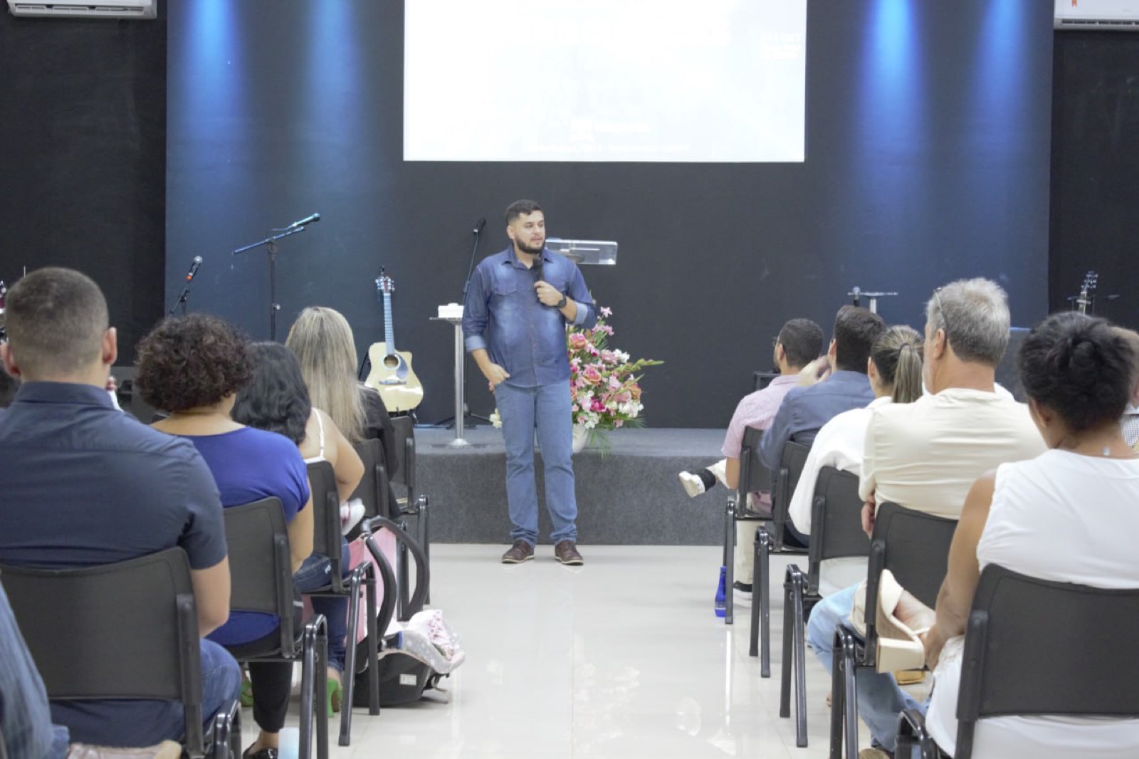 Daniel preaching to a full room, 2023