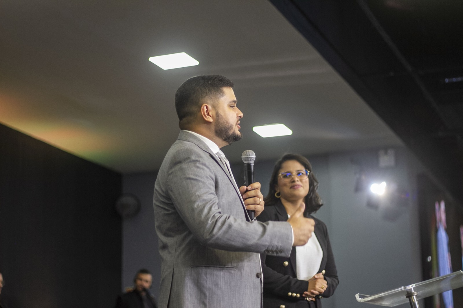 Daniel preaching in a grey suit