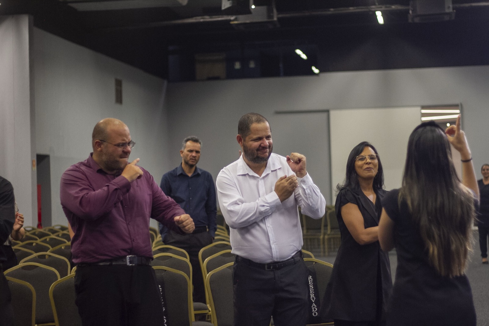 Worshippers signing in Brazilian Sign Language